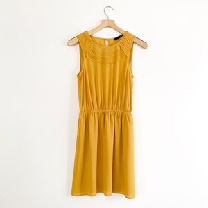 Mustard yellow chiffon mini dress.